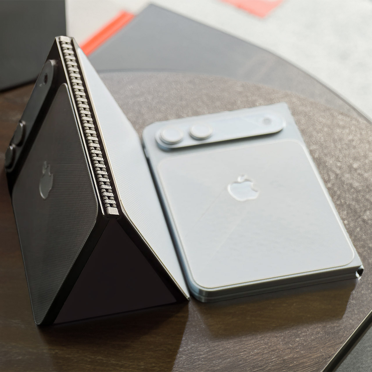 Leaked dummy units showing the iPhone Fold's hinge mechanism in both folded and open positions — the wide gear-style hinge is clearly visible on the left unit.
