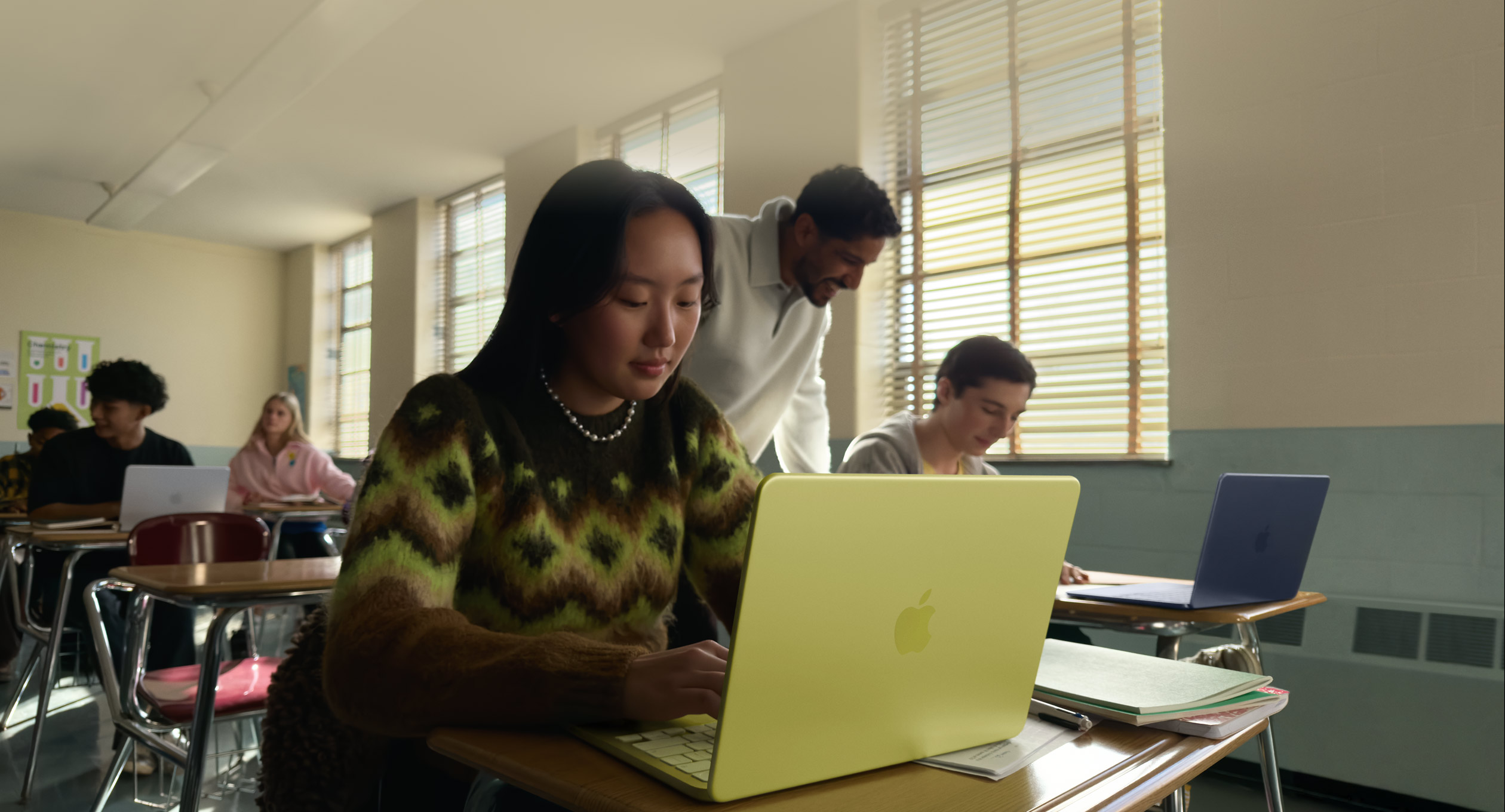 The MacBook Neo Citrus in a classroom — Apple's $499 education pricing makes this the most accessible Mac ever for students.