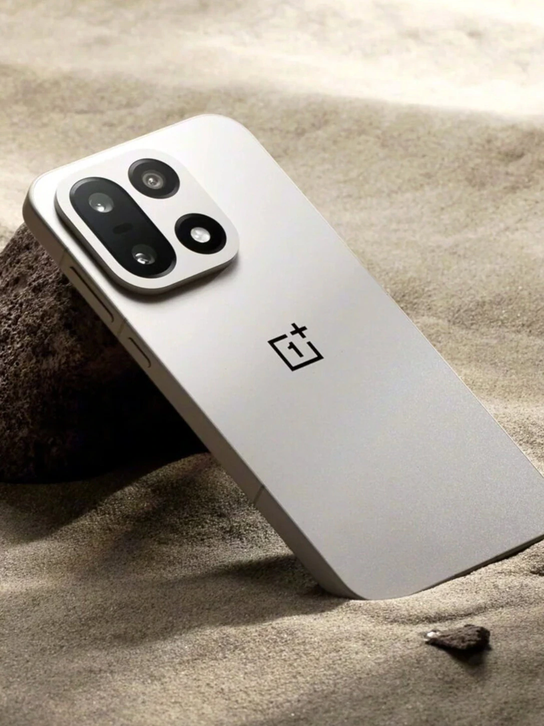 The OnePlus 15 propped against a desert stone — the Hasselblad-tuned camera system is exceptional, which makes its absence from Western shelves all the more frustrating. (Image: OnePlus)