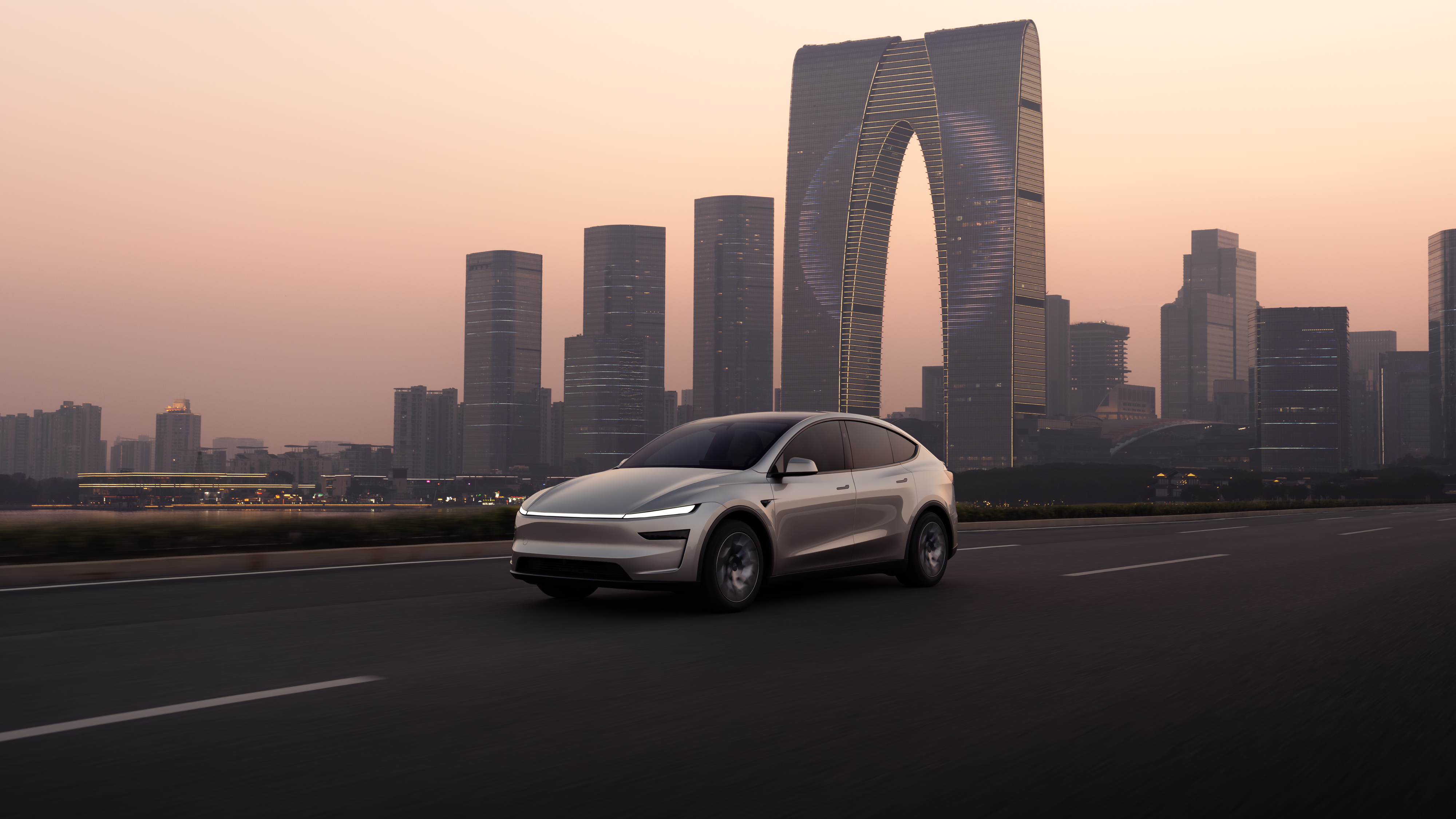The Model Y L in Quicksilver, front three-quarter view — the longer wheelbase is visible in the extended roofline and door proportions. Image: Tesla